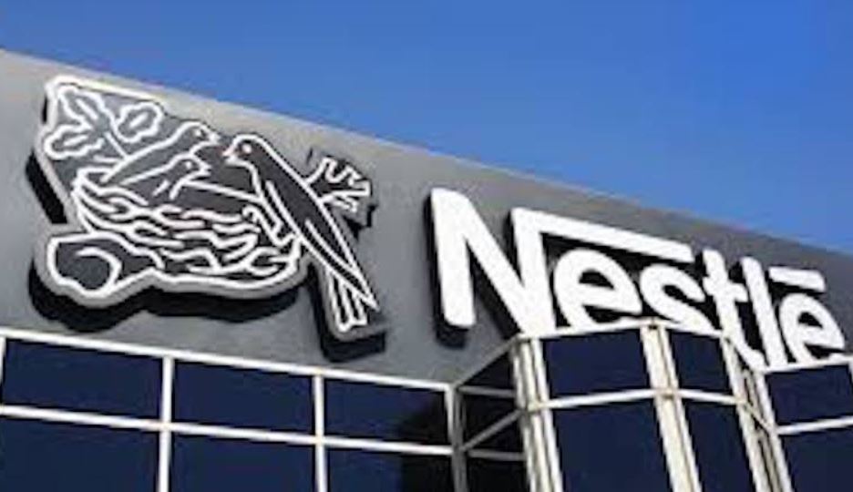 A group of young trainees working on technical equipment at Nestlé Technical Training Center.