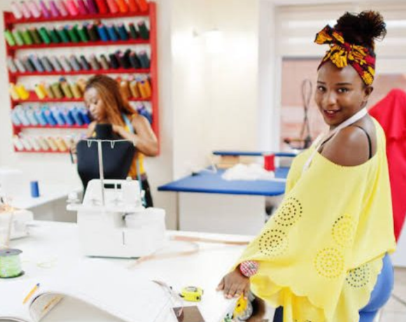 Tailors working at SMEDAN sewing hub with steady electricity and free sewing machines in Abuja.